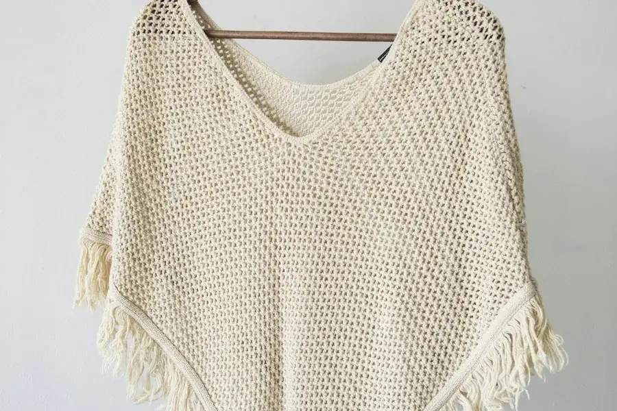Cream open-knit top on a hanger