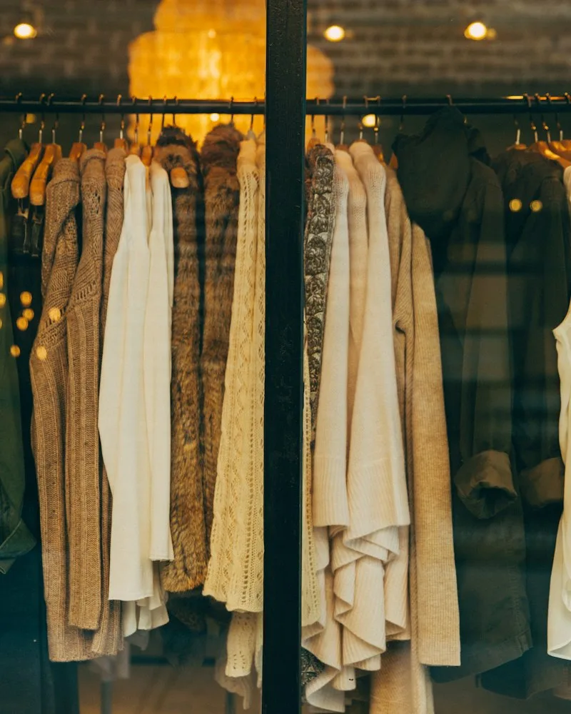Neutral and pastel garments hanging on a boutique rail